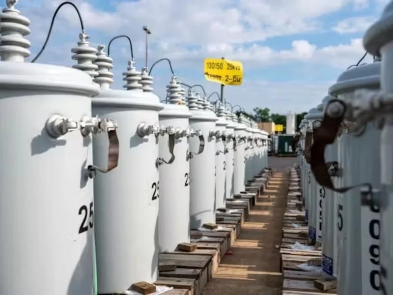 pole-mounted distribution transformer on the left
