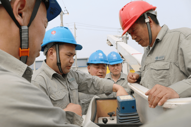 A team of engineers reviewing blueprints for a distribution transformer upgrade project