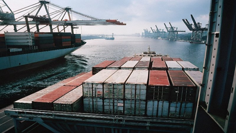 a cargo ship at a port, illustrating international shipping risks